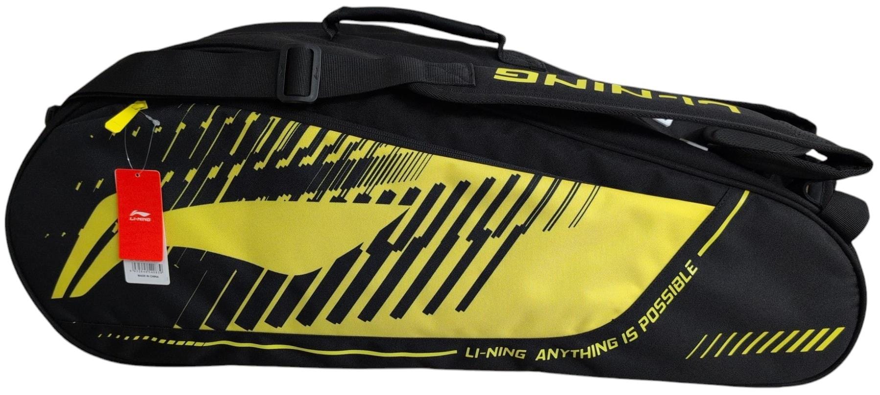 The Li-Ning Training Series 3 Racket Badminton Bag in black/yellow features abstract yellow patterns, a shoulder strap, the "ANYTHING IS POSSIBLE" slogan, and a red tag on the zipper—perfect for stylish players on the go.