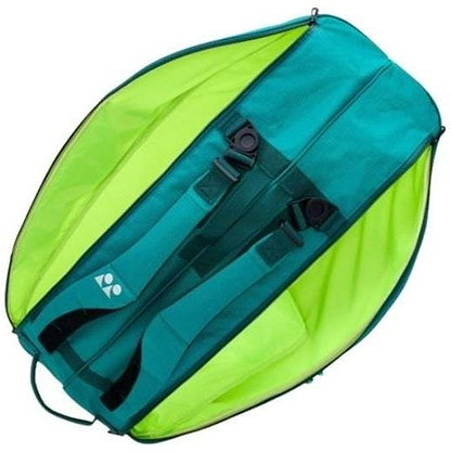 A Yonex 92426EX 6 Racket Pro Badminton Bag in dark green lies on its back, featuring two padded shoulder straps and a small white Yonex logo; the unzipped bag reveals its spacious interior.