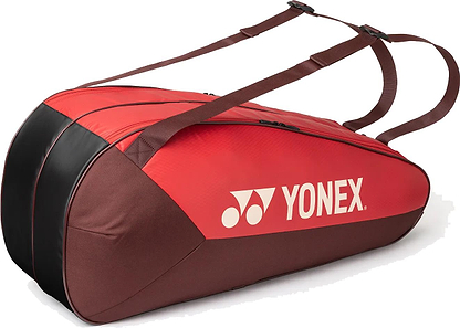 The Yonex 42526EX Team 6 Racket Badminton Bag in ruby red features two shoulder straps, the Yonex logo on the side, and is designed to securely carry up to six badminton rackets.