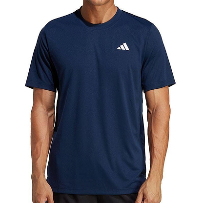 A person wearing the ADIDAS Men's Club Badminton T-Shirt in navy from adidas, featuring a small white logo on the chest. This shirt, made with AEROREADY fabric, has short sleeves and the person is standing against a plain background.