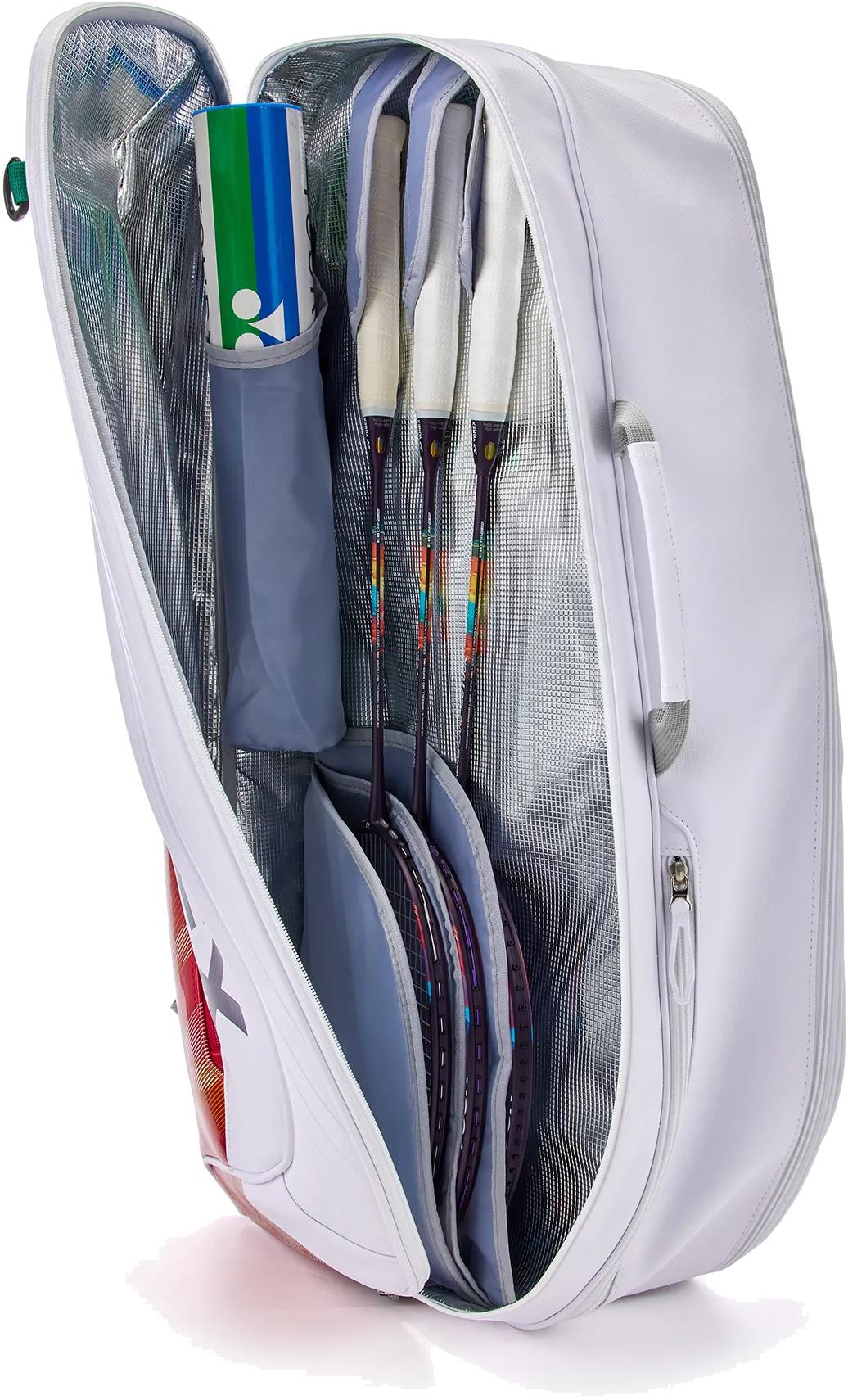 The Yonex 02626EX Expert 6 Racket Badminton Bag - White is open, showing three rackets and a tube of shuttlecocks in separate compartments. It features a handle, zippered side pocket, and Thermo Guard protection for your gear.