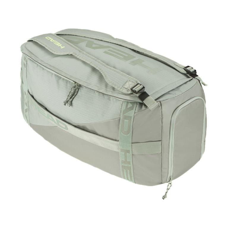 Presenting the HEAD Pro Duffle Bag M - LNLL, a sleek light gray duffle endorsed by Matteo Berrettini. This bag prominently features the "HEAD" logo on its side and strap and is equipped with a top zipper closure, multiple compartments for organized storage, reinforced handles, and an adjustable shoulder strap for optimal comfort.