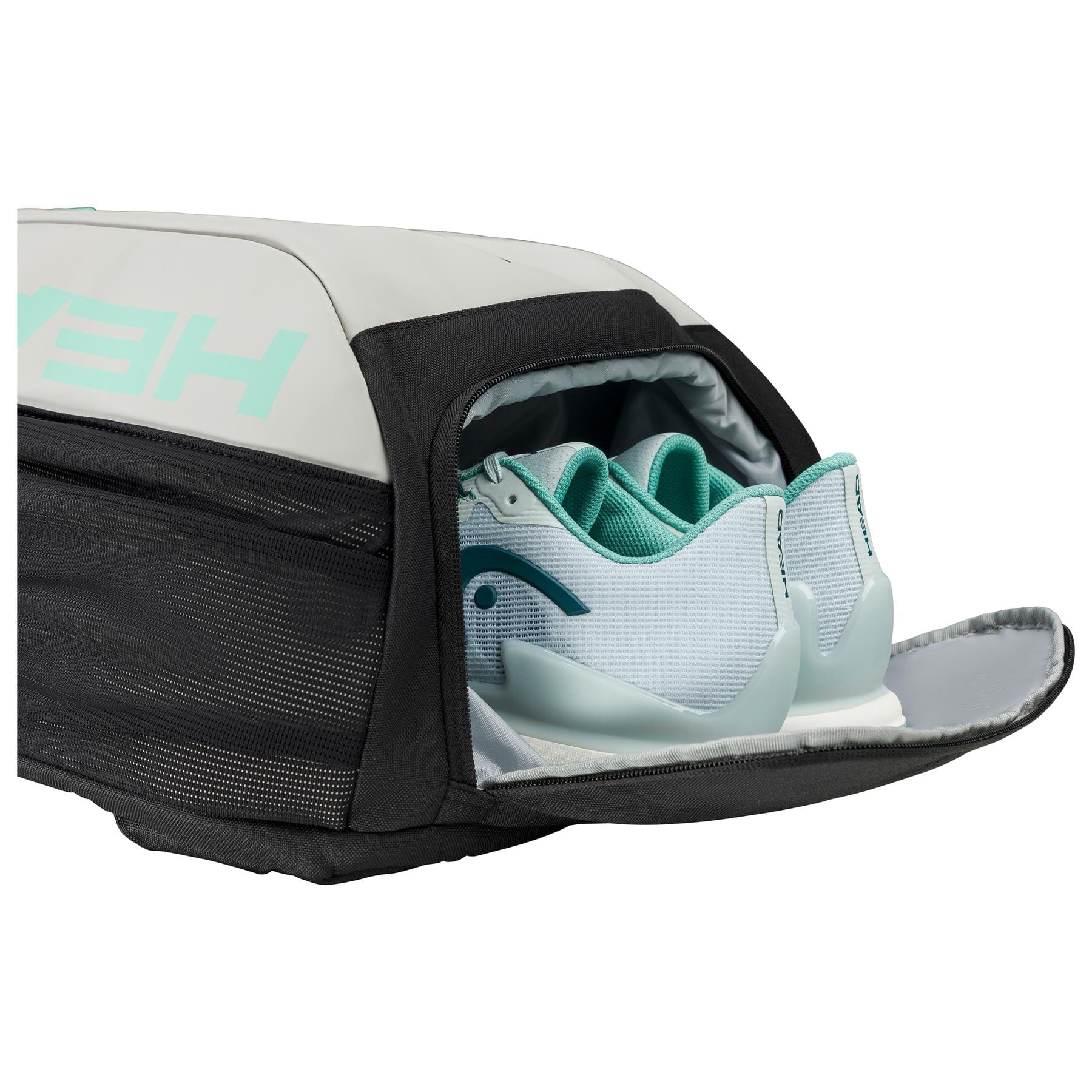 The HEAD Tour Badminton Backpack - CCTE by HEAD is a stylish black backpack with gray and teal accents, featuring an open shoe compartment that displays a pair of white and teal athletic shoes.
