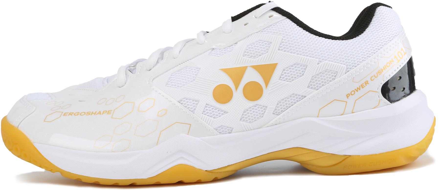 The Yonex Power Cushion SHB 101 Badminton Shoes in white and gold feature a honeycomb pattern, "ERGOSHAPE" and "POWER CUSHION 101" text, dual-circle logo, and excellent shock absorption in the yellow and white sole.