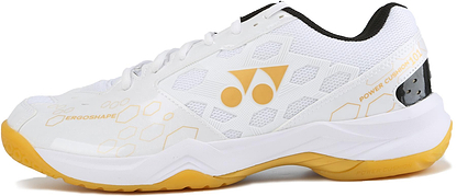 The Yonex Power Cushion SHB 101 Badminton Shoes in white and gold feature a honeycomb pattern, "ERGOSHAPE" and "POWER CUSHION 101" text, dual-circle logo, and excellent shock absorption in the yellow and white sole.