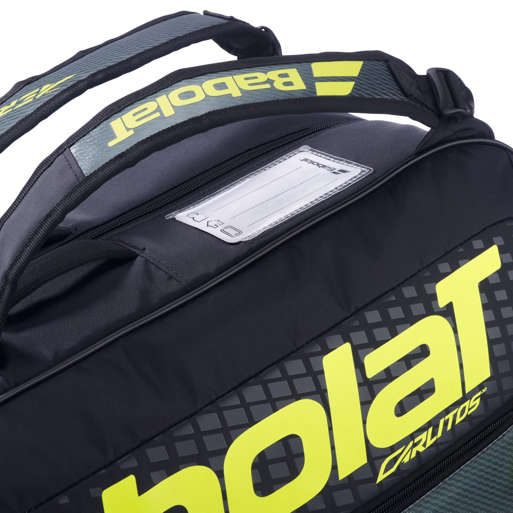 Close-up of the Babolat RH Carlitos Junior 3 Racket Badminton Bag in black/yellow, a kids bag with "Babolat" branding, name tag holder on top, and thick padded shoulder straps for comfort.