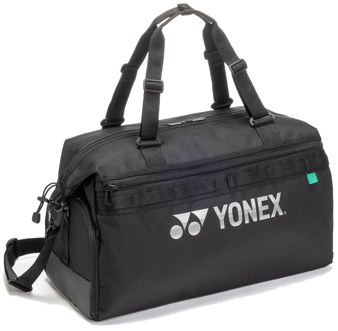 The Yonex BA72611EX Gearlogic Badminton Boston Bag in black is made from recycled polyester, with double handles, a detachable shoulder strap, zippered compartments, and a white Yonex logo on the side.