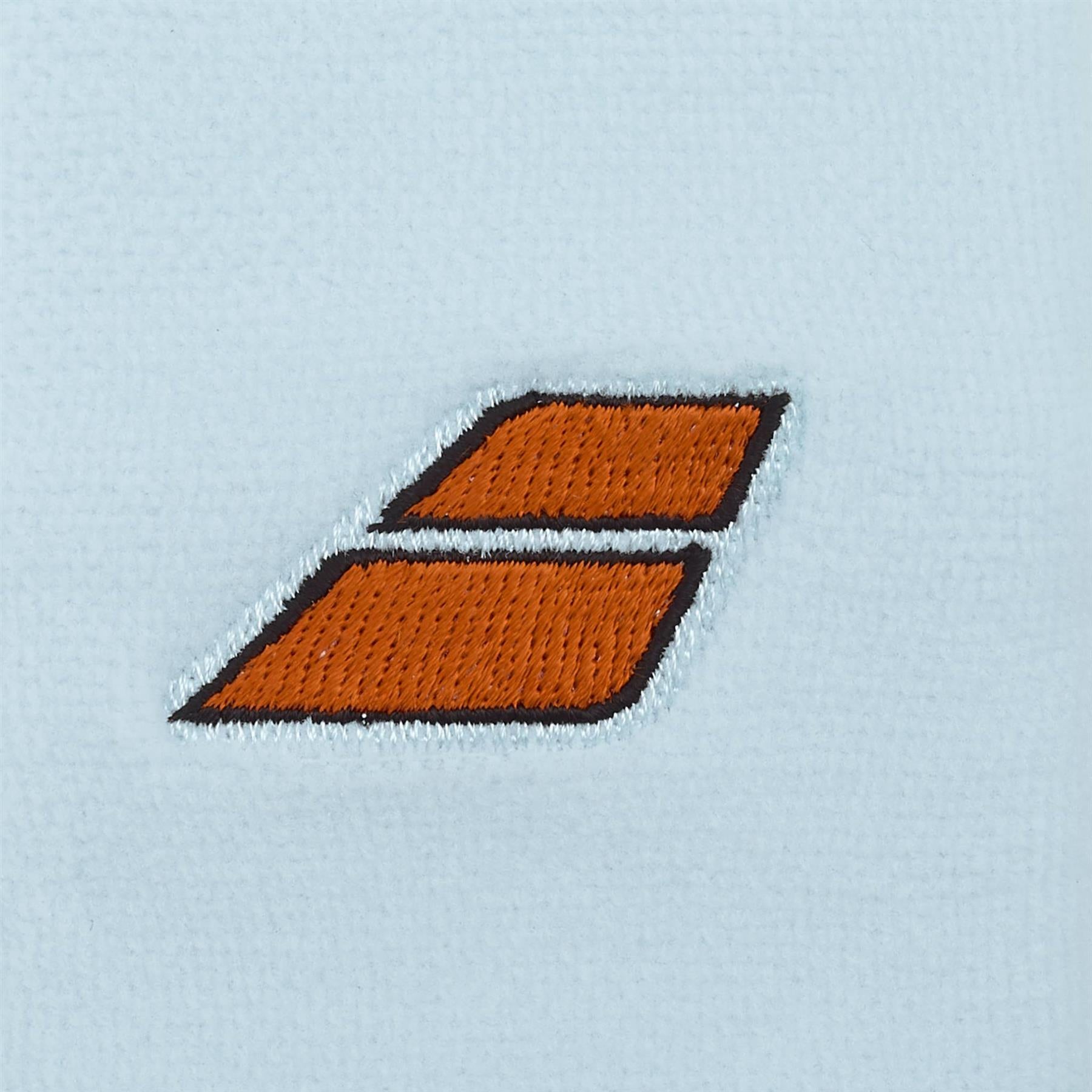 Two parallel orange rectangles with black borders, one above the other and slightly slanted, are embroidered on the illusion blue Babolat Terry Jumbo Wristband—a classic tennis accessory.