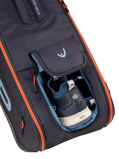 A HEAD Pro 9 Racket Badminton Bag L - Navy with orange zippers, featuring CCT+ climate control tech, is shown open to reveal dark blue and white athletic shoes inside.