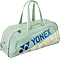 The Yonex 02631WEX Expert Tournament Badminton Bag in smoke green features cream handles and zipper, blue Yonex logo and text, a subtle shuttlecock pattern, and Thermo Guard technology to protect your gear.