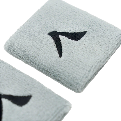 Close-up of two gray Kanso 7cm Wristbands featuring a black embroidered logo resembling a bird's wing. Made from absorbent fabric for comfort, they're displayed on a light surface, accentuating the texture.