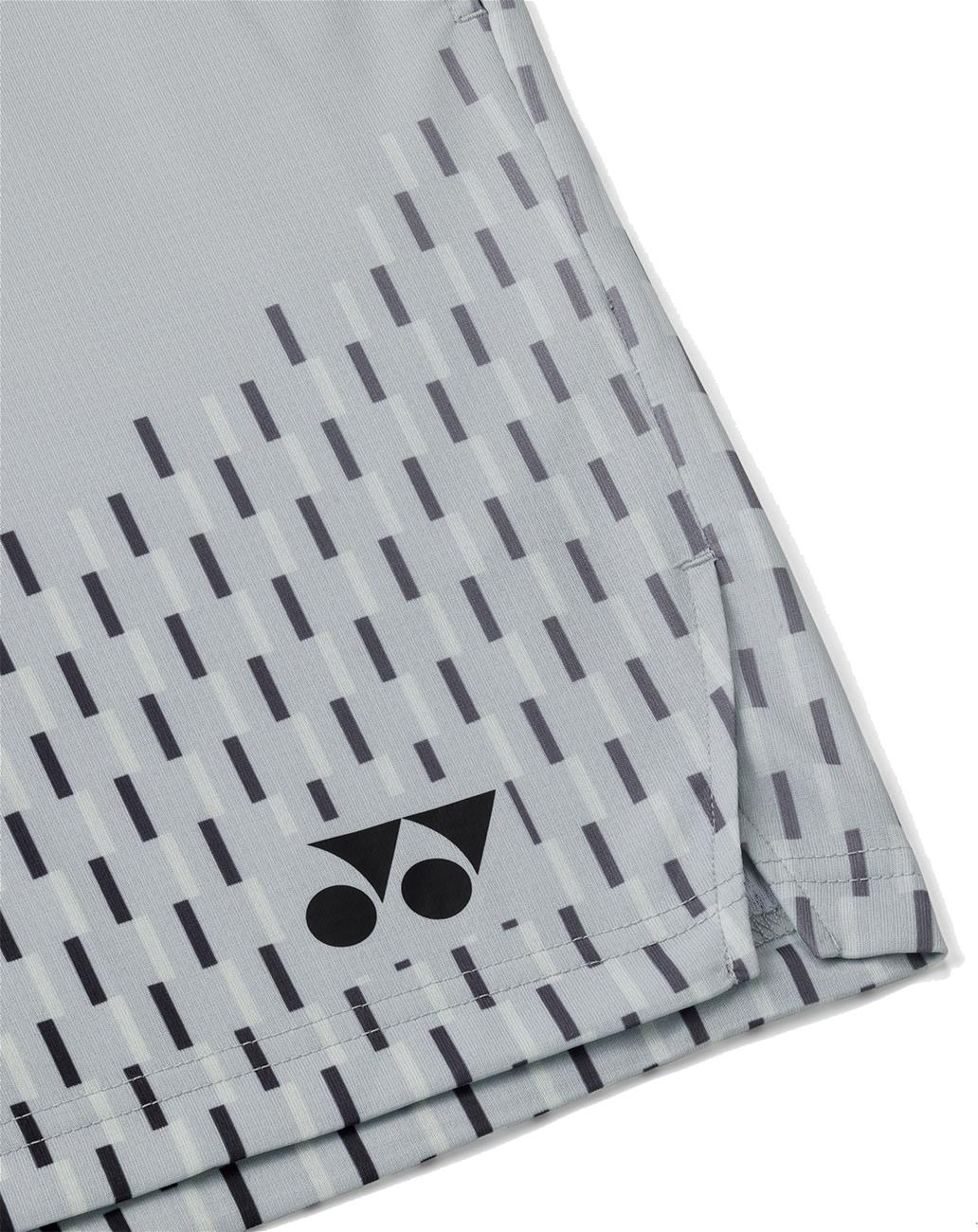 Close-up of the Yonex 15241EX Knit Men's Badminton Shorts in silver grey, showing light gray fabric with diagonal dark lines and a black Yonex logo near the hem—designed for comfort and performance.