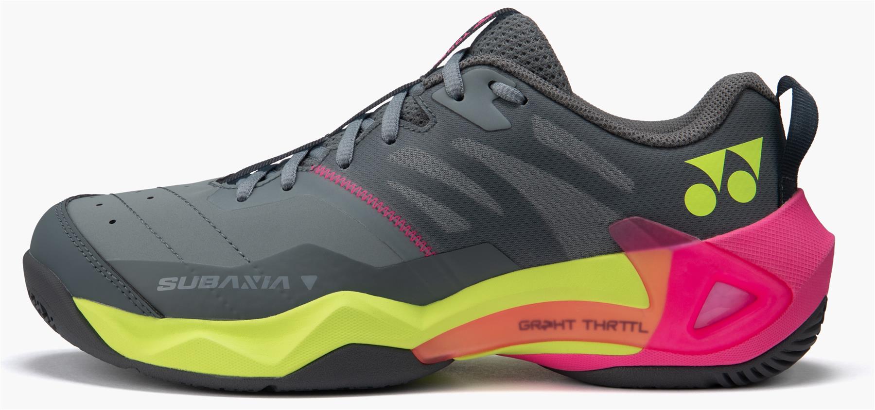 The Yonex Subaxia GT WIDE Unisex Badminton Shoes in grey feature neon yellow and pink accents, a black sole, "SUBANIA" text on the side, a yellow logo near the heel, and Power Cushion Rev for superior comfort.