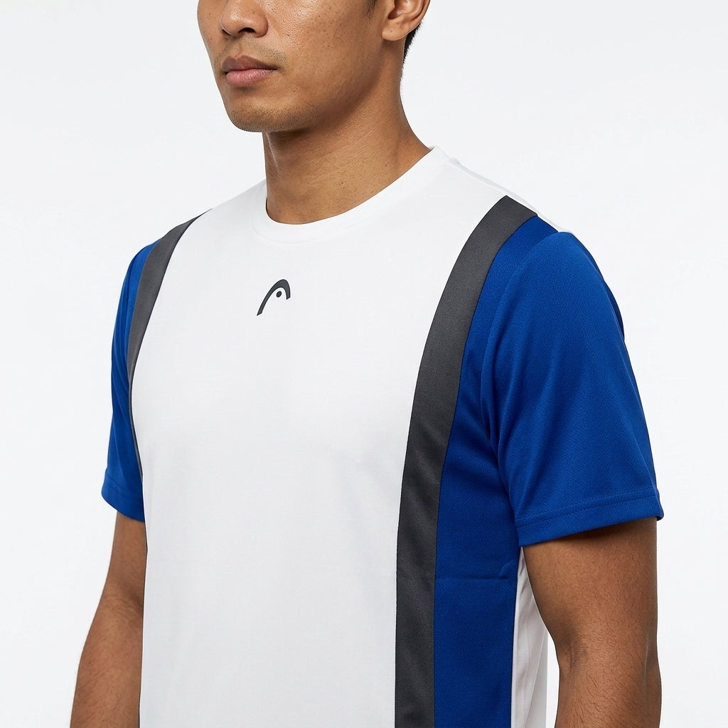 A man stands against a white background in the HEAD Club Tech 25 Men's Badminton T-Shirt by HEAD, featuring royal blue sleeves, dark vertical stripes, and moisture transfer microfiber for breathable comfort.