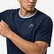 Wearing the HEAD Performance Mens Badminton T-Shirt - Navy, featuring a white collar trim and small logo, a man poses with one arm raised against a plain background—a stylish men's badminton apparel pick from HEAD.
