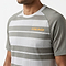 A man wears the HEAD Performance Mens Badminton T-Shirt - XPWG, featuring gray and white stripes, moisture-wicking fabric, and an orange HEAD logo on the left chest, shown from shoulders to mid-torso against a plain background.