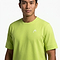 A man wearing a HEAD Slice II Men's Badminton T-Shirt by HEAD, in light green with moisture-wicking fabric and a small white chest logo, stands against a plain white background.