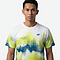 A young man with short black hair wears a Yonex YTM2025A Mens Badminton T-Shirt - White by Yonex, featuring green, blue, and yellow abstract patterns, standing against a plain white background and looking directly at the camera with a neutral expression.