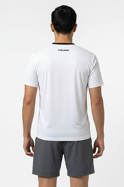 A man faces away from the camera, wearing a white HEAD Blur Mens Badminton T-Shirt - ROXU and gray shorts, set against a plain white background.