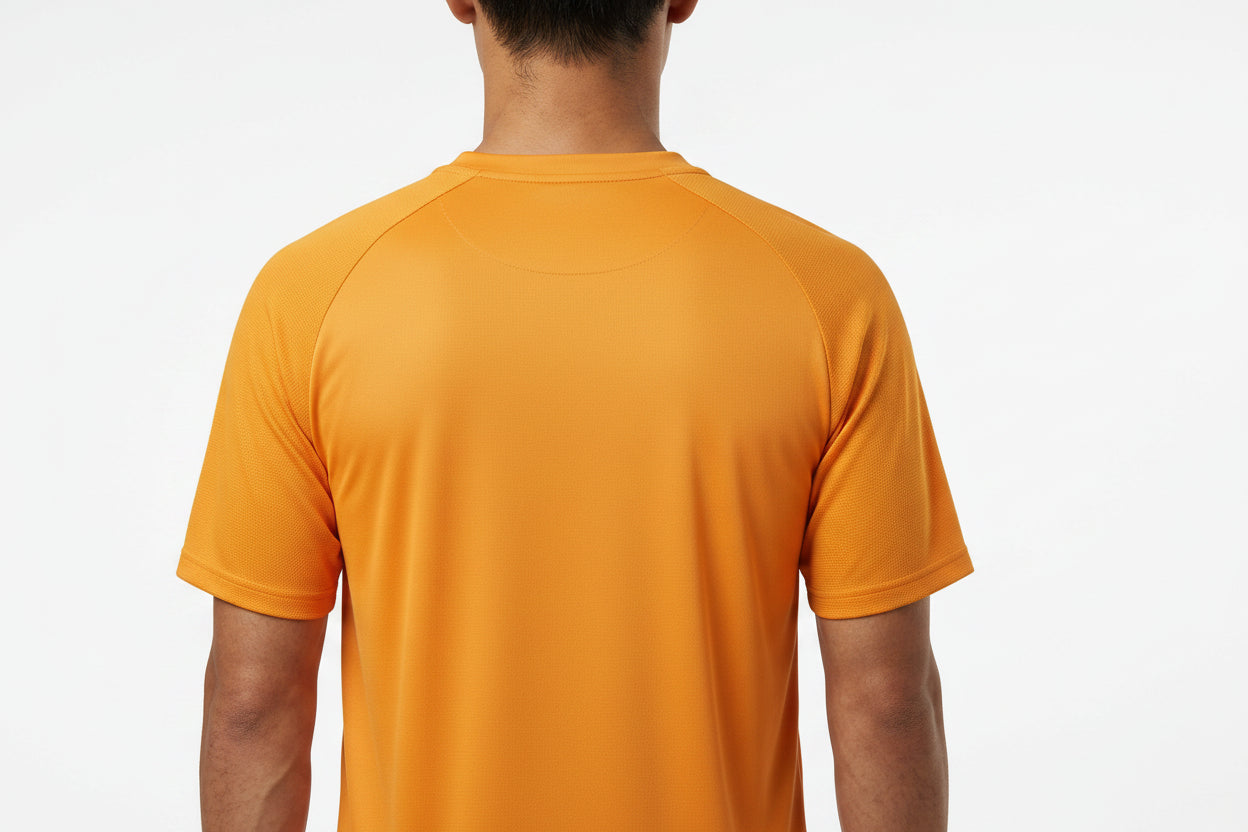 A person is shown from the back against a white background wearing the HEAD Performance Mens Badminton T-Shirt - XPBN, an orange short-sleeve crew neck by HEAD featuring moisture-wicking fabric and shoulder seam details.