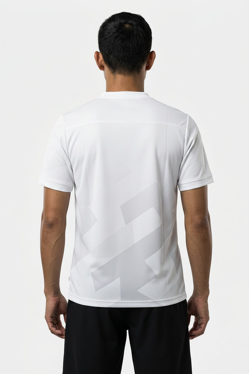 A person with short dark hair, seen from behind, is wearing a white HEAD Pro Men's Badminton T-Shirt - PUXP and black shorts—perfect breathable sportswear by HEAD—set against a plain light background.