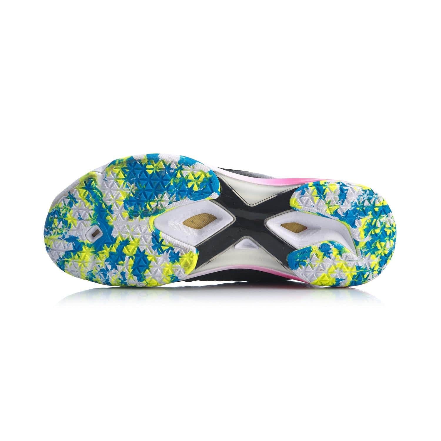 The image highlights the vibrant sole of a Li-Ning Dagger II SE men's badminton shoe in black and pink, displaying a geometric pattern with blue, yellow, and white accents. The design incorporates triangular grips along with a central X-shaped structure in black and white, enhanced by Drive Foam for exceptional performance.