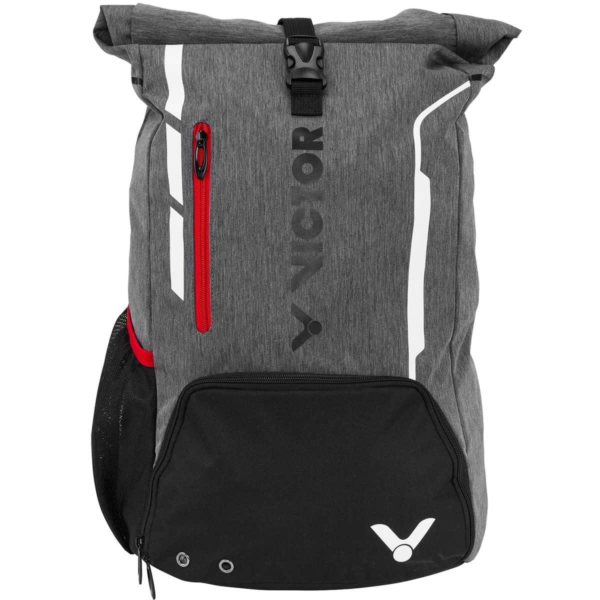 Introducing the Victor Badminton Rucksack 9109, a versatile sports backpack in gray. It features a roll-top closure and a front red zippered pocket. The black base includes a dedicated racket compartment, making it ideal for athletes. Adorned with the "Victor" brand logo and equipped with a mesh side pocket, it provides comfort for all your adventures.
