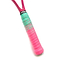 A close-up of the Get A Grip Paint the Lines Pink / Mint Badminton Racket Overgrip showcases its handle wrapped with alternating layers of teal and pink grip tape. This non-slip overgrip, designed by Get A Grip brand, features moisture absorption technology and a small black label with white text. The vibrant colors stand out against the white background.