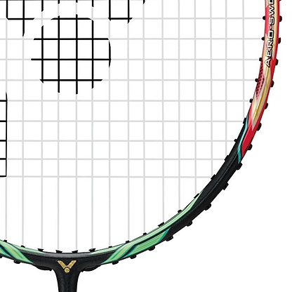 Close-up of the Victor Jetspeed S 10 Q Badminton Racket - Red Black, showcasing a multicolored frame made from Pyrofil Carbon Fibre for lightweight handling. The tightly strung strings form a grid pattern, and the partially visible handle and shaft display a sleek design enhanced by Aero-Sword technology under the renowned Victor brand.