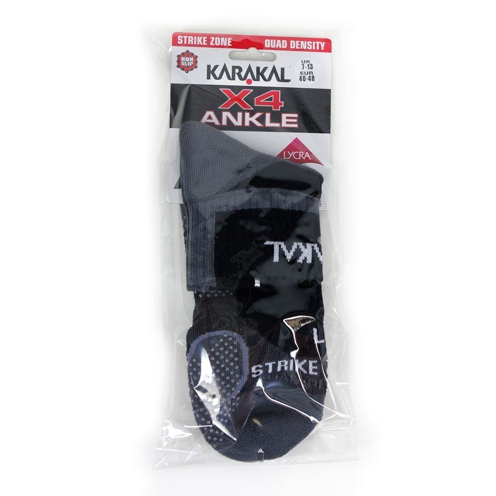 Karakal X4 Men's Technical Ankle Badminton Socks in black and grey, featuring the "Strike Zone" label, quad-density cushioning, and made with Lycra material. They are enhanced with shock-absorbing technology and anti-slip rubber dots. The packaging includes size information for UK 7-13 and EU 40-48.