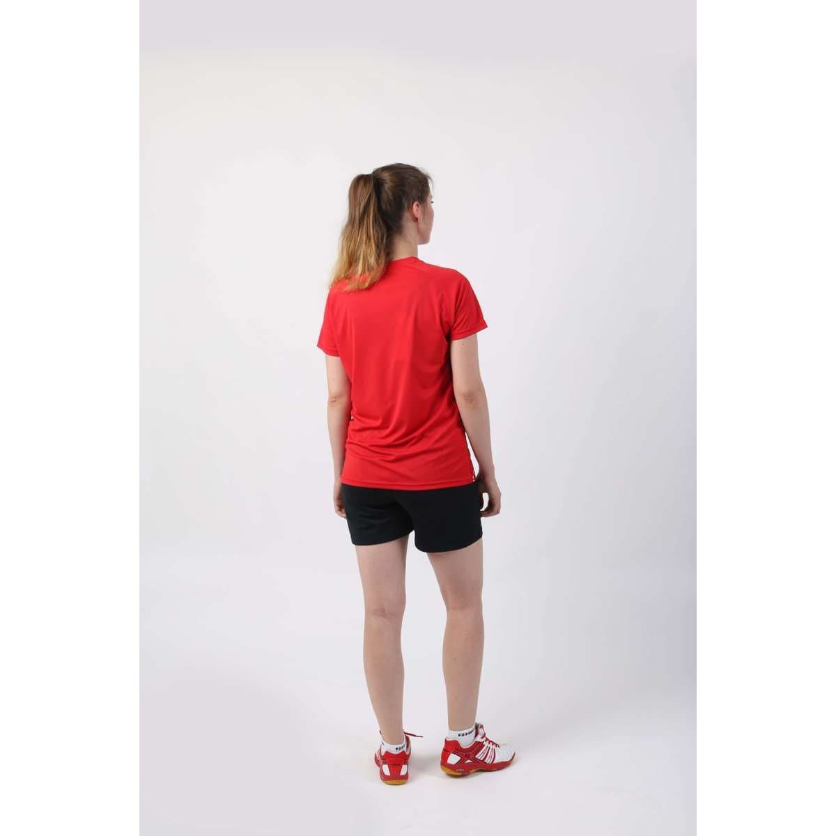 A woman wearing a comfortable, stretch-resistant red shirt reminiscent of a chic FZ Forza Bali Badminton Tee.