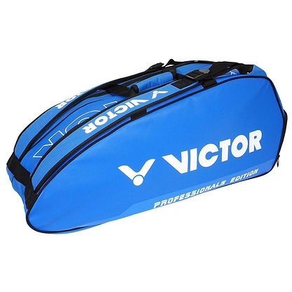 Introducing the Victor Doublethermo Badminton Bag 9111 - Blue, featuring multiple compartments with "Professionals Edition" printed on the side. Specially designed to carry rackets, it is equipped with both a shoulder strap and a handle for convenient carrying.