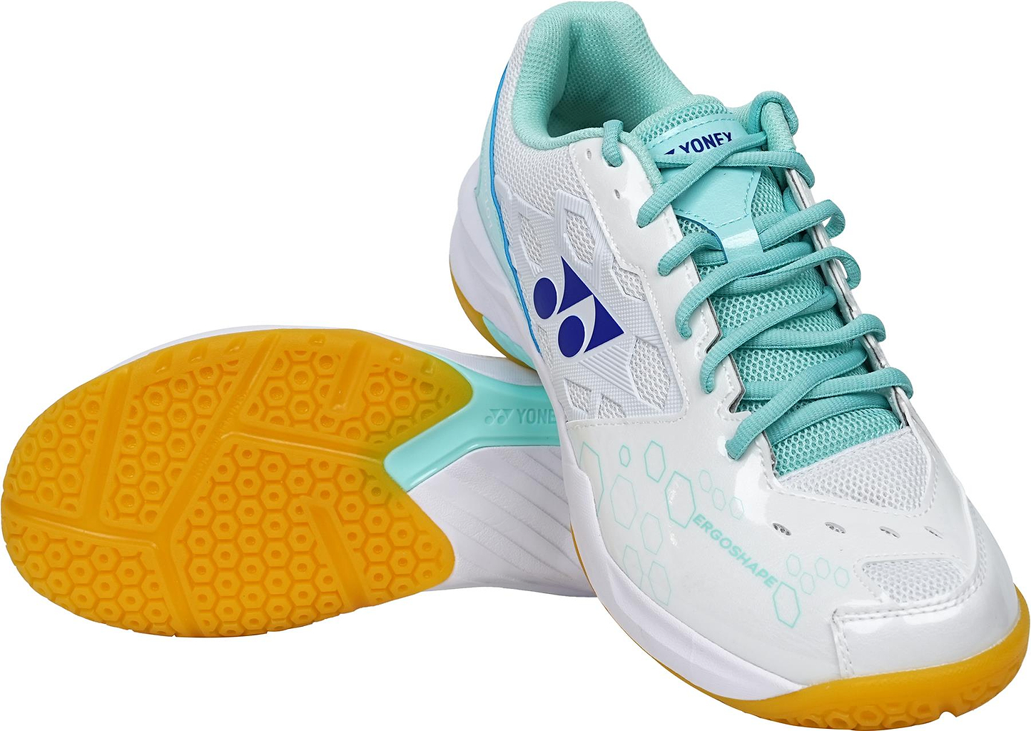 A pair of Yonex Power Cushion SHB 101 Badminton Shoes in white and mint, with yellow soles and a blue side logo. One shoe stands upright while the other displays its tread and advanced shock-absorption sole technology.