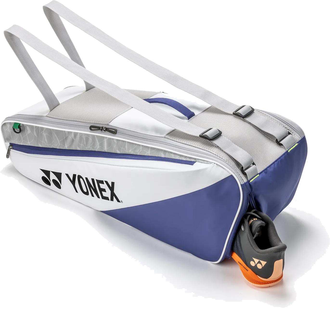 The Yonex BA52526EX Club 6 Racket Badminton Bag in white and blue with gray straps features a handy side compartment—ideal for storing your essentials, including Yonex shoes. Perfect for carrying all your badminton gear.