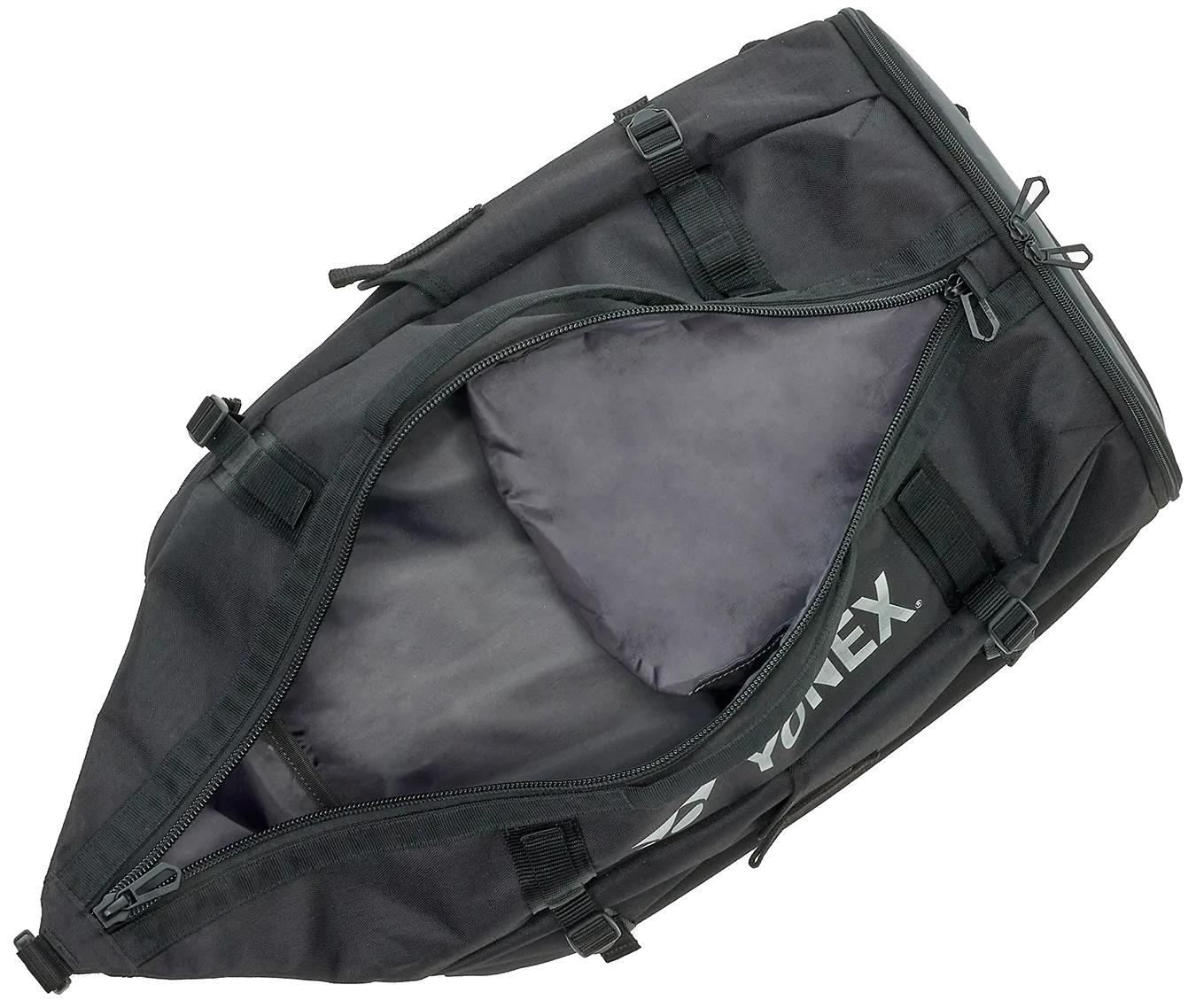 The Yonex BA72612EX Gearlogic Badminton Backpack in black features a main zipper opening to a spacious gray-lined 40L interior, with multiple exterior straps and buckles for secure storage.