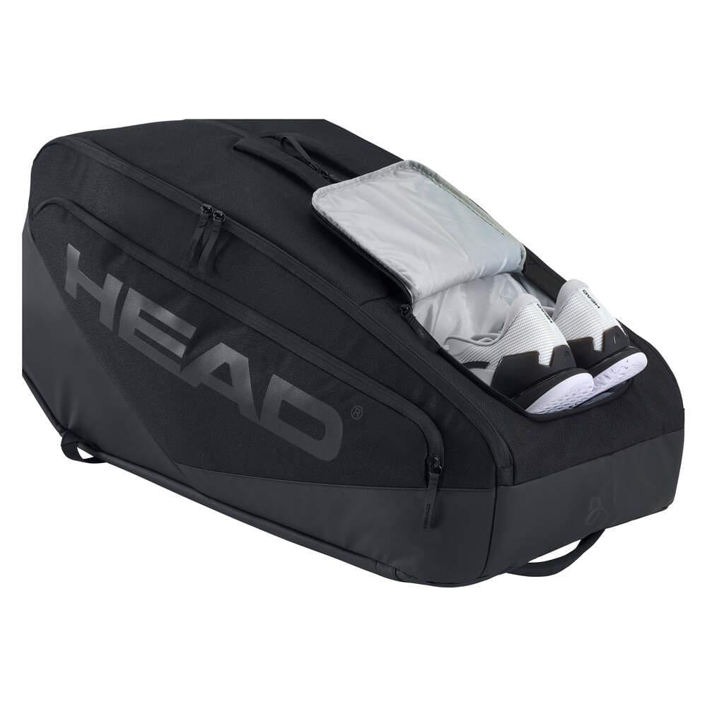 The HEAD Pro X 12 Racket Badminton Racket Bag XL - Black, inspired by Novak Djokovic, features a prominent HEAD logo and a side pocket unzipped to reveal white athletic shoes inside.