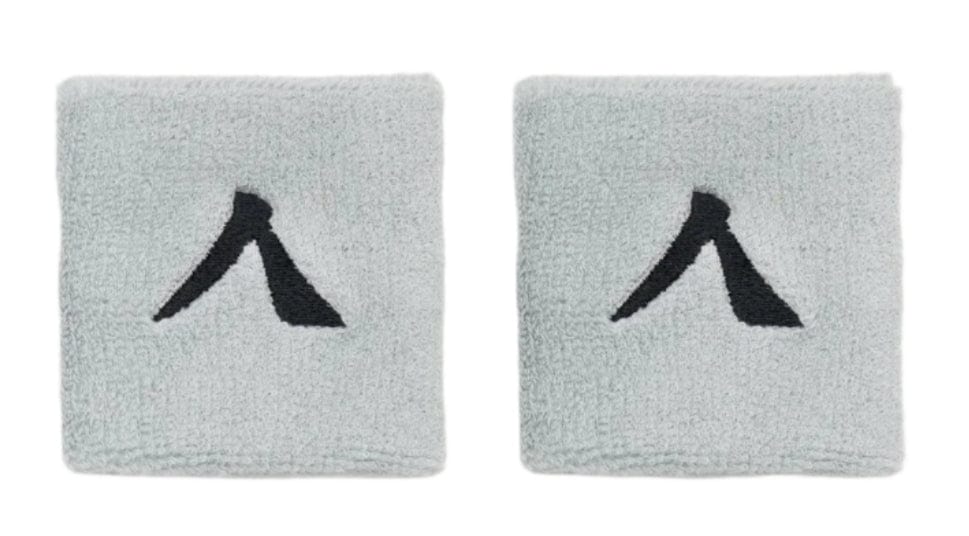 The Kanso 7cm Wristband - 2 Pack in grey boasts two absorbent, minimalist light gray bands with a black design. Set against a white background, they seamlessly blend style and functionality for maximum comfort.
