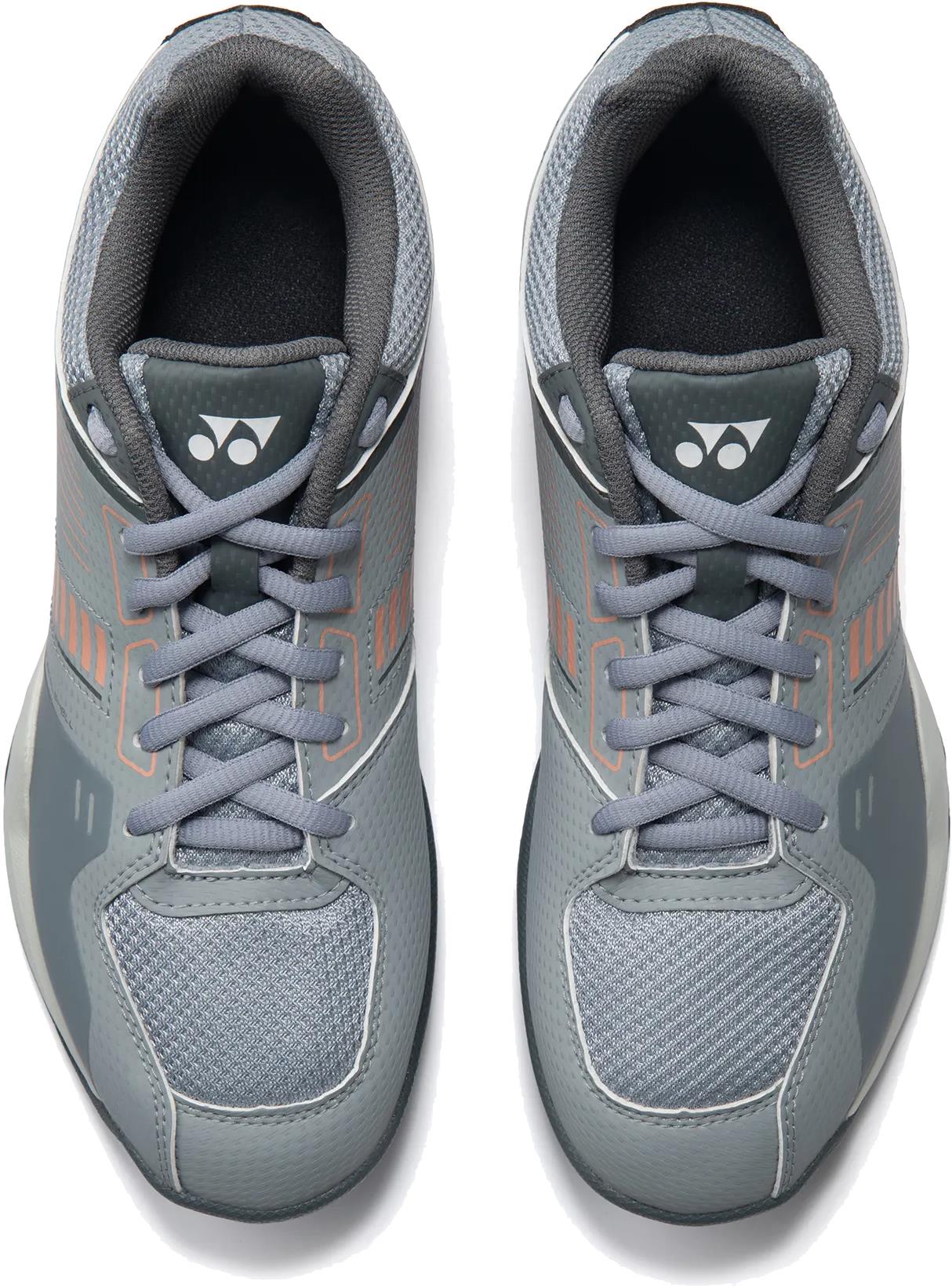 The Yonex Strider Flow Unisex Badminton Shoes in light grey, featuring mesh uppers, light gray laces, and logoed tongues, are ideal for beginner players seeking comfort and style on the court.