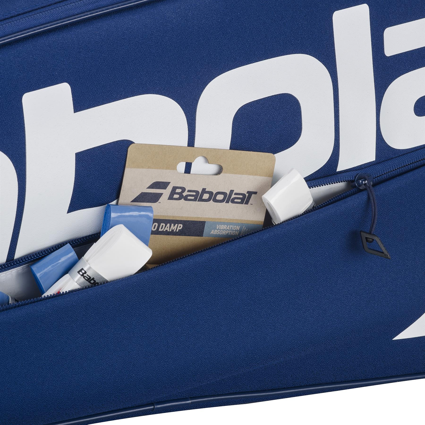 A close-up of the blue Babolat Court XS 3 Racket Badminton Bag with a partially open zipper, revealing Babolat-branded accessories and packaging inside this compact badminton bag.