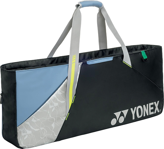 The Yonex BA52531EX Club Tournament Badminton Bag in black and blue features a floral pattern, gray handles, and the Yonex logo on the front—a stylish and durable bag for badminton players.