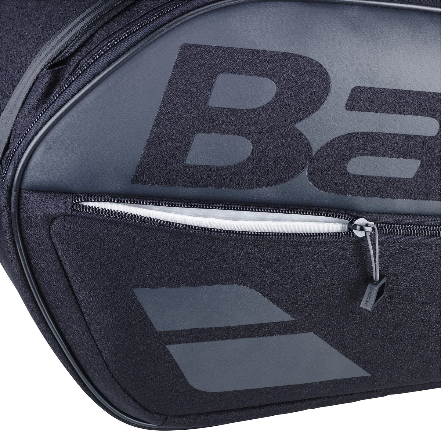 Close-up of the Babolat Court L 9 Racket Badminton Bag in black, showcasing a bold "B" on the main compartment. It features a zippered front pocket with visible zipper and pull tab, made from durable textured fabric ideal for eco-friendly sports enthusiasts.