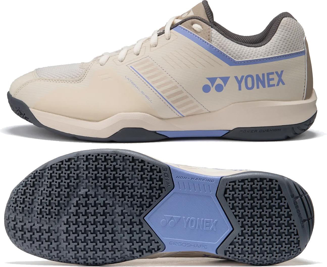 The Yonex Strider Flow WIDE Men's Badminton Shoes in light beige feature blue and gray accents, a textured non-marking rubber sole, and prominent Yonex branding—perfect for beginner players.