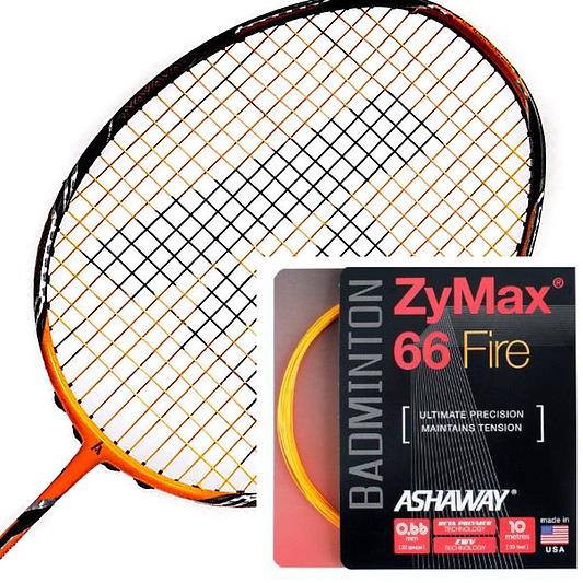 An orange badminton racket with black strings is showcased alongside a stylish black and red packet of Ashaway Zymax 66 Fire Badminton String in Orange (0.66mm - 10m), renowned for its micro gauge strings. The set highlights precision and tension stability, complemented by a vibrant yellow coil.