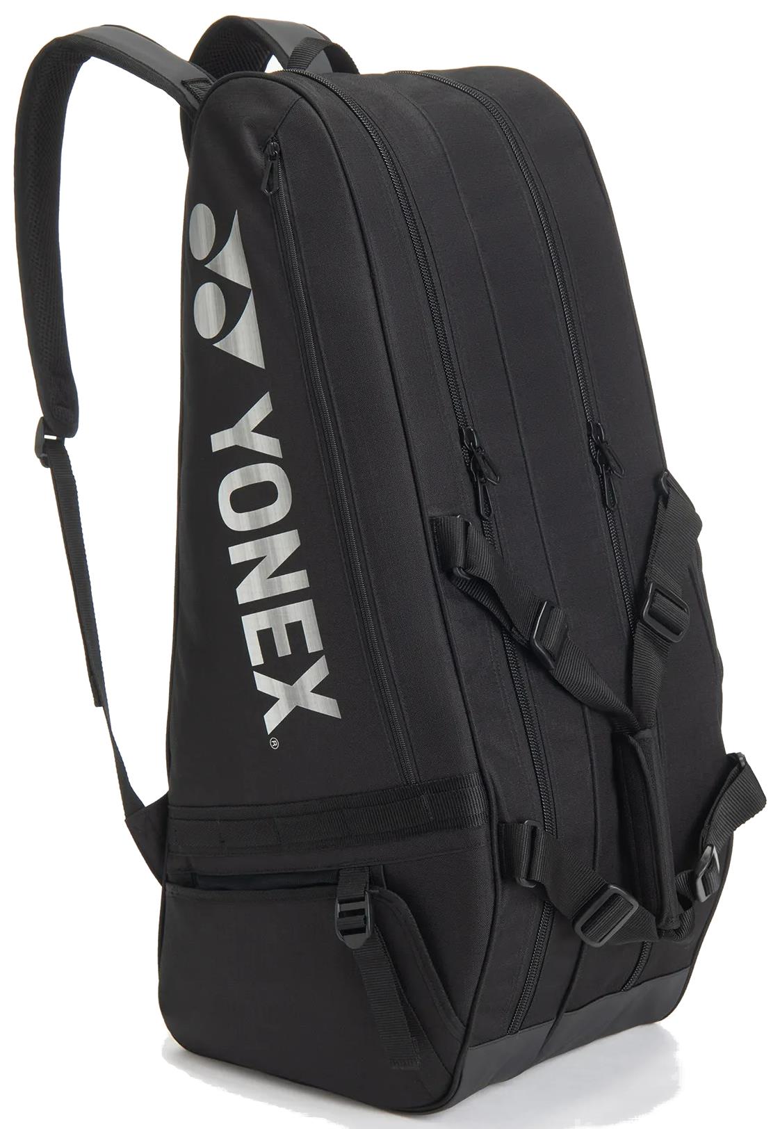 The Yonex BA72626EX Gearlogic 6 Racket Badminton Bag in black features multiple zippered compartments, adjustable shoulder straps, and a white Yonex logo—ideal for serious players seeking reliable storage.