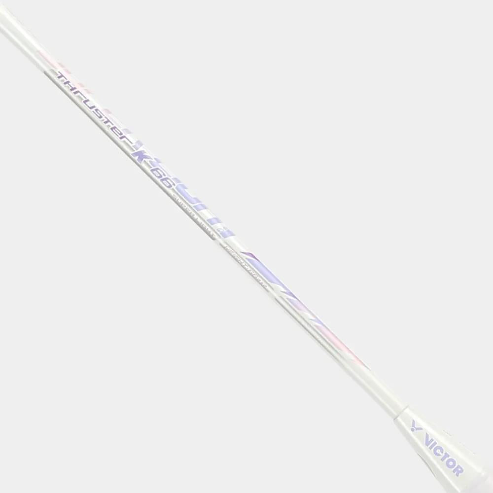 A close-up of the Victor Thruster K 66 AJ 7U Badminton Racket shaft in white/purple, featuring the Victor brand and model printed boldly.