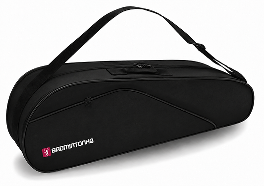 The BadmintonHQ 6 Racket Badminton Bag - Black features a shoulder strap, zippered compartments, and a white and pink “BADMINTONHQ” logo. It holds up to 6 rackets for easy storage and transport.