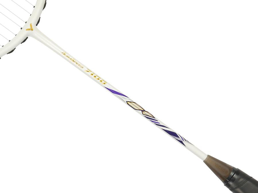 Close-up of the Victor Auraspeed 7100 4U Badminton Racket by Victor, showcasing gold and purple geometric designs on a high resilience graphite shaft, black strings, and a brown grip at the handle end.