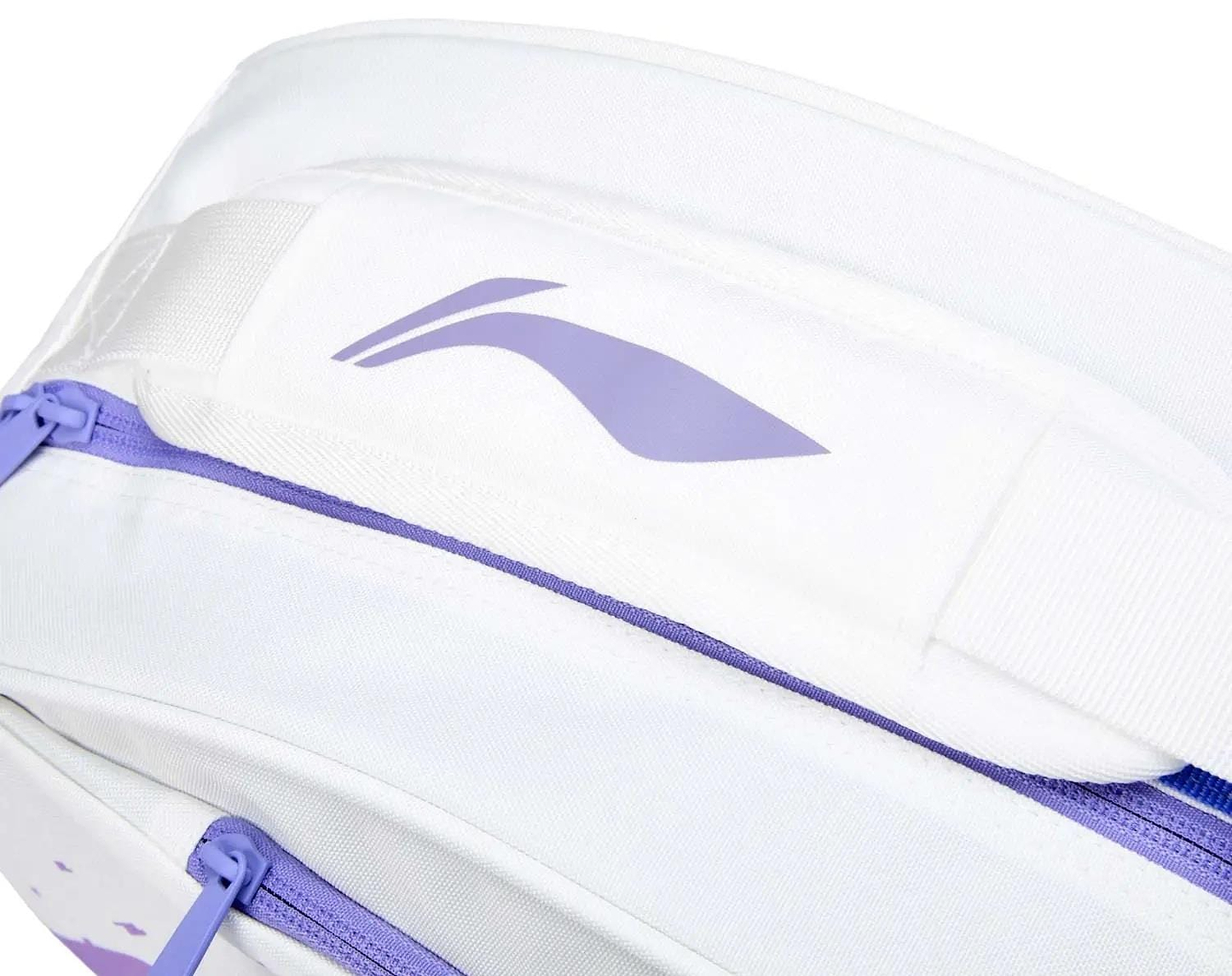 Close-up of the Li-Ning Training Series 3 Racket Badminton Bag in white with a purple zipper and abstract logo on the padded strap. The sleek fabric, branded details, and stylish purple accents keep your badminton gear organized.