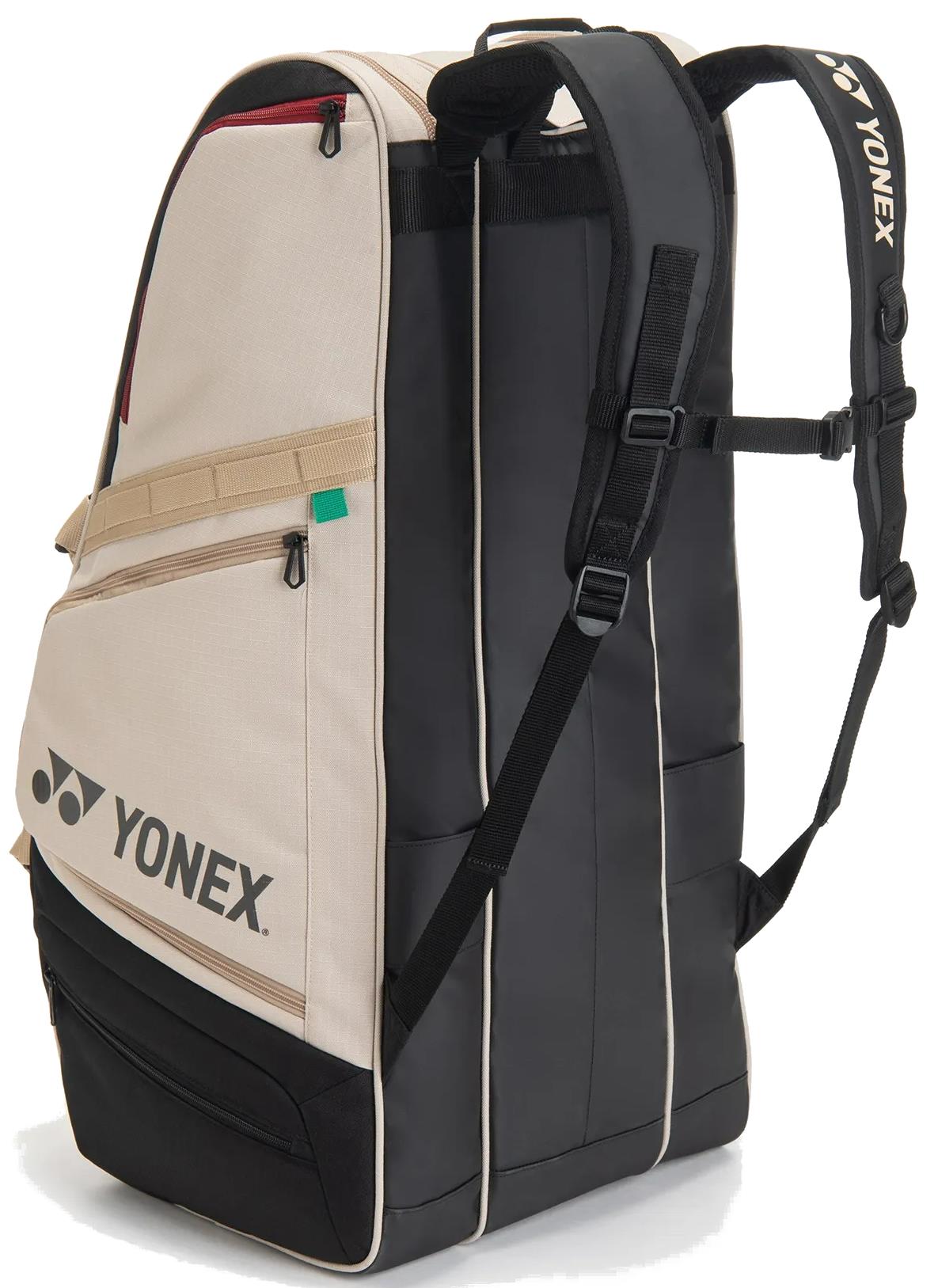 The Yonex BA72629EX Gearlogic 9 Racket Badminton Bag in beige features multiple zippered compartments, padded shoulder straps, and the Yonex logo—perfect for carrying your badminton gear stylishly.