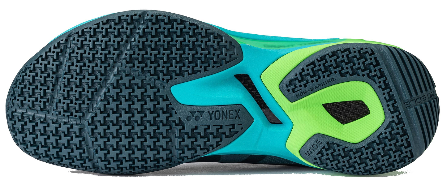 Close-up of the sole of Yonex Subaxia GT WIDE 2026 Unisex Badminton Shoes in dark green, highlighting its textured grip pattern, Yonex branding, Power Cushion Rev technology, and multiple grip zones.